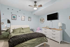 Bedroom with light colored carpet and a ceiling fan