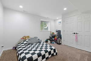 Carpeted bedroom featuring recessed lighting and baseboards