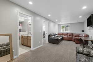 Living area featuring light carpet and recessed lighting