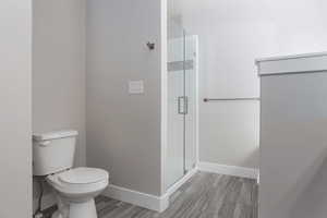 Bathroom with a stall shower and baseboards
