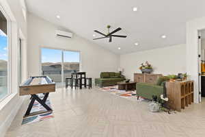 Living room with lofted ceiling, recessed lighting, and ceiling fan