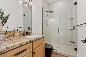 Bathroom featuring a shower stall and vanity