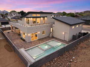 Back of house with a patio area, stucco siding, and a fenced backyard