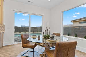 Dining space with light wood-type flooring and recessed lighting