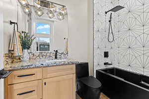 Full bath featuring vanity and shower / bath combination