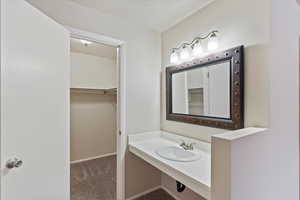 Bathroom vanity with a spacious walk-in closet
