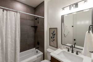 Full bath with shower / bathtub combination with curtain and vanity