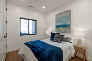 Bedroom featuring wood finished floors and recessed lighting