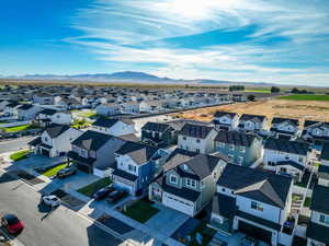 Aerial perspective of suburban area with a mountain backdrop