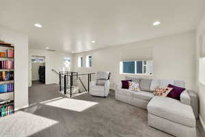 Carpeted living room with recessed lighting