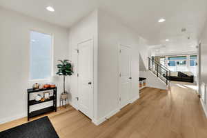 Hall featuring recessed lighting, light wood-type flooring, and stairway