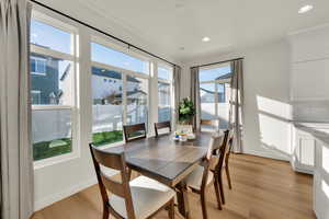 Dining area featuring light wood finished floors and recessed lighting
