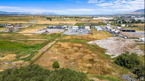 Aerial view of property and surrounding area with a mountain backdrop