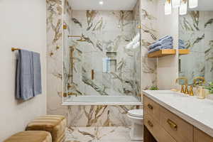 Full bath featuring vanity and tiled shower / bath combo