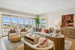 Living area featuring light wood-style flooring and recessed lighting