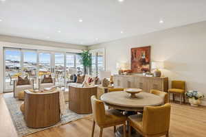 Dining space with light wood-style floors and recessed lighting