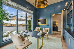 Office space featuring a decorative wall and light wood-style flooring