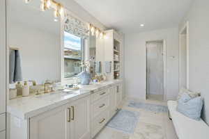 Bathroom with double vanity and a stall shower
