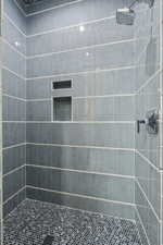 Full bath with a tile shower
