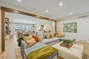 Living room with wood finished floors and recessed lighting
