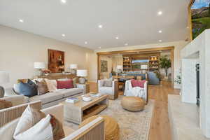 Living area featuring recessed lighting, light wood finished floors, and a fireplace