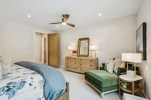 Carpeted bedroom featuring recessed lighting and a ceiling fan