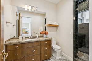 Ensuite bathroom featuring vanity and a shower stall