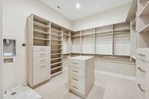 Spacious closet featuring light carpet