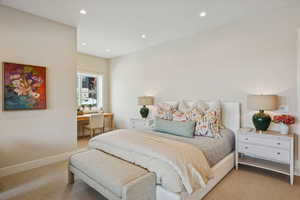 Carpeted bedroom featuring an office area and recessed lighting