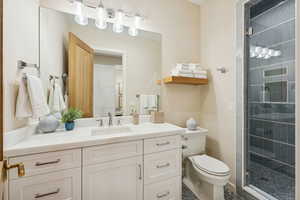 Full bath with vanity, a shower stall, and tile patterned floors