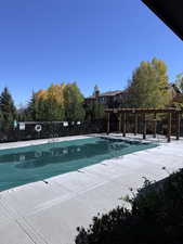 Community pool with a pergola and a patio