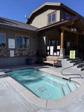 View of pool with a pool and a community hot tub
