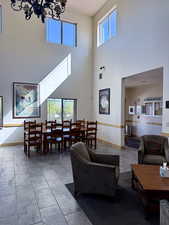 Living room with a towering ceiling and a chandelier