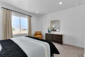 Carpeted bedroom featuring recessed lighting and a textured ceiling