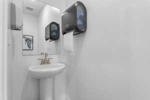 Bathroom featuring baseboards and a sink