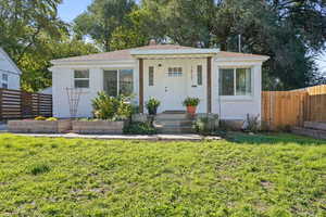 Bungalow featuring a shingled roof and stucco siding