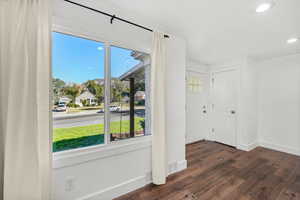 Entrance foyer with dark wood-style flooring and recessed lighting