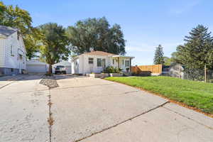 View of front facade with an outbuilding and a garage