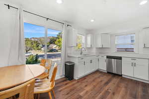Kitchen featuring white cabinetry, dark wood-type flooring, plenty of natural light, and recessed lighting