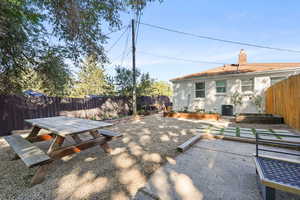 Fenced backyard with a patio area, a garden, and outdoor dining area