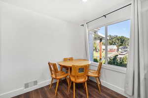 Dining room featuring baseboards and dark wood finished floors