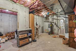 Unfinished below grade area featuring water heater