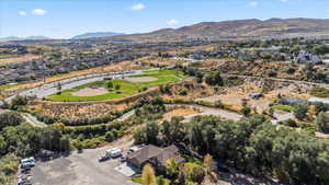Aerial view of property's location featuring mountains and nearby suburban area