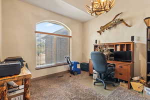 Office featuring carpet and a chandelier