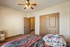 Bedroom featuring carpet, ceiling fan, and a closet