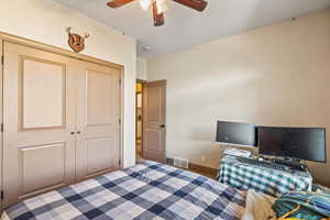 Bedroom featuring a closet, a ceiling fan, and carpet flooring