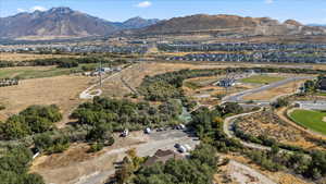 Aerial view of property's location featuring a mountainous background