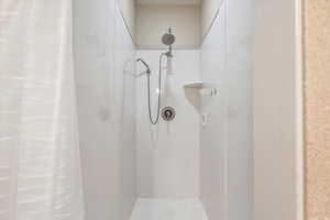 Bathroom featuring a shower with curtain