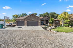 Ranch-style home featuring concrete driveway, an attached garage, brick siding, and a front yard