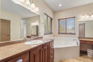 Bathroom with vanity, light tile patterned flooring, a bath, recessed lighting, and a shower